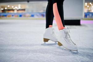 Legs of ice skater on the ice rink. photo