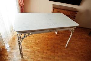 White wooden carved table in flat. photo