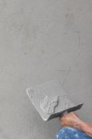 Builder worker plastering concrete photo