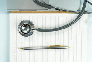 Medical stethoscope for doctor checkup on notepad photo