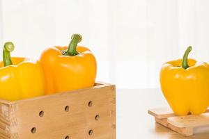 Fresh yellow bell peppers in box photo