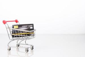 Credit card in shopping cart on white photo