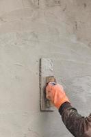 Builder worker plastering concrete photo