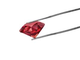 Dazzling diamond red on white background held in diamond tweezers. 3d render photo