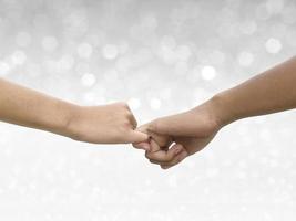 Image of a couple holding hands on shining bokeh background photo