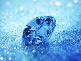 Blue dazzling diamond on blue shining bokeh background. concept for chossing best diamond gem design photo