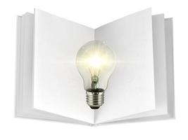 concept creativity with bulbs that shine glitter on over open book photo