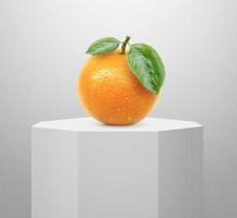 Orange fruit, on Shiny white round pedestal podium photo