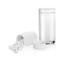 Complete prescription set up showing a glass of water, a white blank plastic medicine bottle and white pill. 3d render photo