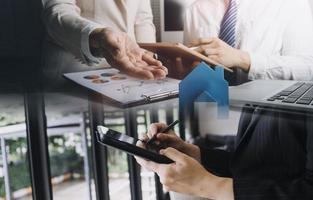 Businessman and team analyzing financial statement Finance task. with smart phone and laptop and tablet. Wealth management concept photo