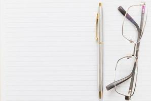 Notebook open blank page and Eyeglasses photo
