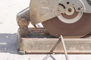 Worker cutting metal with grinder photo