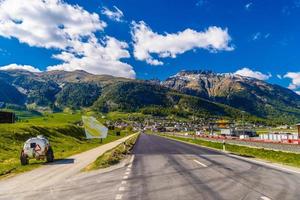 Road with Alps mountains in Samedan, Maloja Graubuenden Switzerland photo