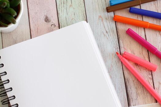 Notebook blank page and colorful felt-tip pens photo