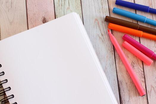 Notebook blank page and colorful felt-tip pens photo