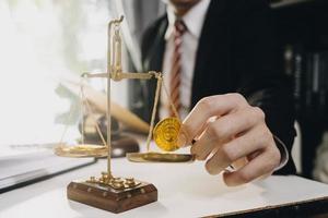 Business and lawyers discussing contract papers with brass scale on desk in office. Law, legal services, advice, justice and law concept picture with film grain effect photo