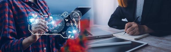 Selective focus. Architect team planning design apply renewable or solar energy on architectural building model with virtual reality technology hologram. Alternative green energy in future concept. photo