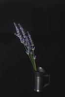 still life with vintage measuring goblet with lavender flowers photo