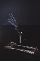 still life with cutlery with an iron vintage measuring cup with lavender flowers photo