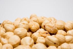 Whole hazelnuts on the white background. Healthy vegetarian snack. Close-up photo. Copy-space for your text. High quality photo