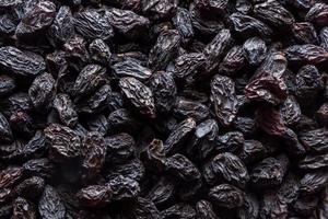 Black raisins background. Vegetarian healthy snack. Organic food. Vegetable diet. High quality photo