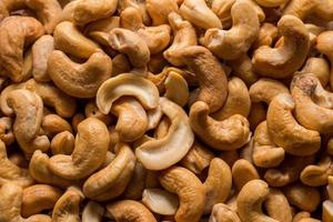 Whole roasted cashew nuts background. Vegetarian healthy snack. Organic food. Vegetable diet. Top view. High quality photo