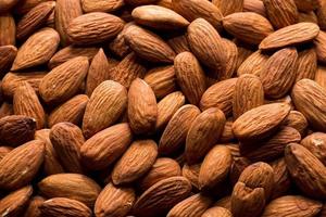 Whole almond nuts background. Vegetarian healthy snack. Organic food. Vegetable diet. High quality photo