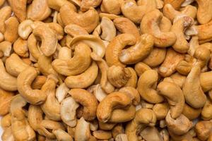 Whole roasted cashew nuts background. Vegetarian healthy snack. Organic food. Vegetable diet. Top view. High quality photo