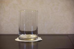 empty glass on wooden table photo