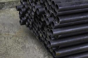 Stacked aluminum metal pipes. Heavy industry production photo