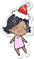 distressed sticker cartoon of a friendly girl wearing santa hat vector