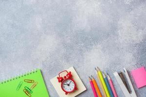 School supplies, notebooks pencils on grey background with copy space. photo