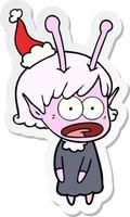 sticker cartoon of a shocked alien girl wearing santa hat vector