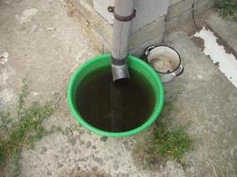 Drinking bowl for animals from rainwater collected from the roof photo