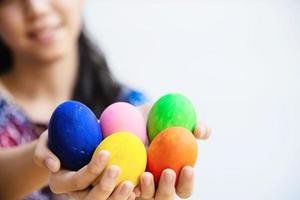 Child showing colorful Easter eggs happily - Easter holiday celebration concept photo