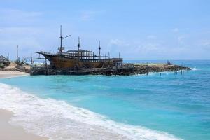 Wooden sailing ship constructed in marine workshop on the beautiful sunny day, a place for maintenance and parking. photo