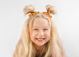 Portrait of a little smiling girl on Halloween with pumpkin lights photo