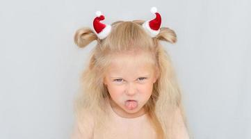 Girl with two Santa hats photo