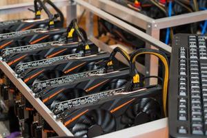 Graphics cards standing in a row in home mining farm. Close-up shot. Cryptocurrency industry. photo