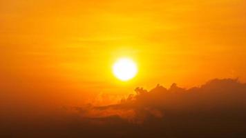 Bright sun and cloud on orange sky natural background photo