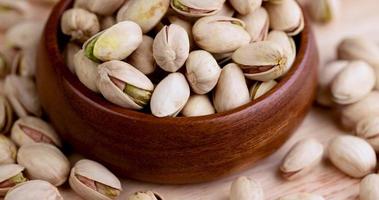 fried pistachios with cracked shells are spinning photo