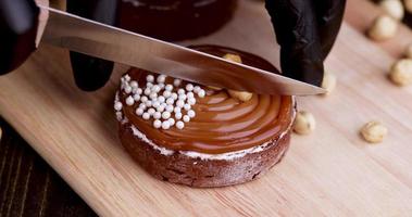 cut into pieces of delicious tartlets with buttercream and caramel with nuts photo