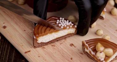 cut into pieces of delicious tartlets with buttercream and caramel with nuts photo