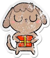 distressed sticker of a cute cartoon dog with christmas present vector