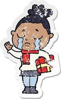 distressed sticker of a cartoon crying woman with christmas gift vector