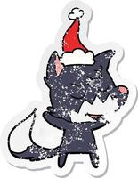 friendly distressed sticker cartoon of a fox wearing santa hat vector