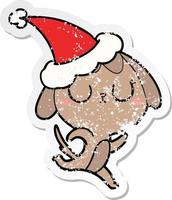 cute distressed sticker cartoon of a dog wearing santa hat vector