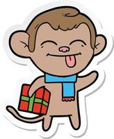 sticker of a funny cartoon monkey with christmas present vector