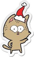 sticker cartoon of a cat wearing santa hat vector