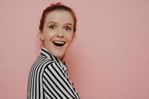 Greatly surpirsed brunette teen girl in striped shirt photo